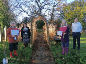 Primrose Hospice gardening volunteers awarded with certificate and flowers