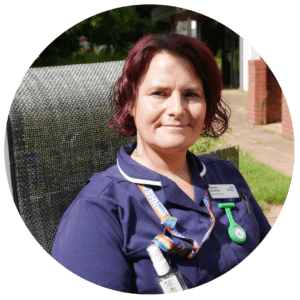 A Nurse sat in the Primrose Hospice garden