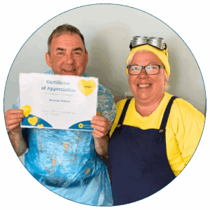 A man stood with a certificate and a woman dressed as a minion.