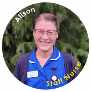A woman stood outside in a nurses uniform. Text on image reads, Alison, Staff Nurse. 